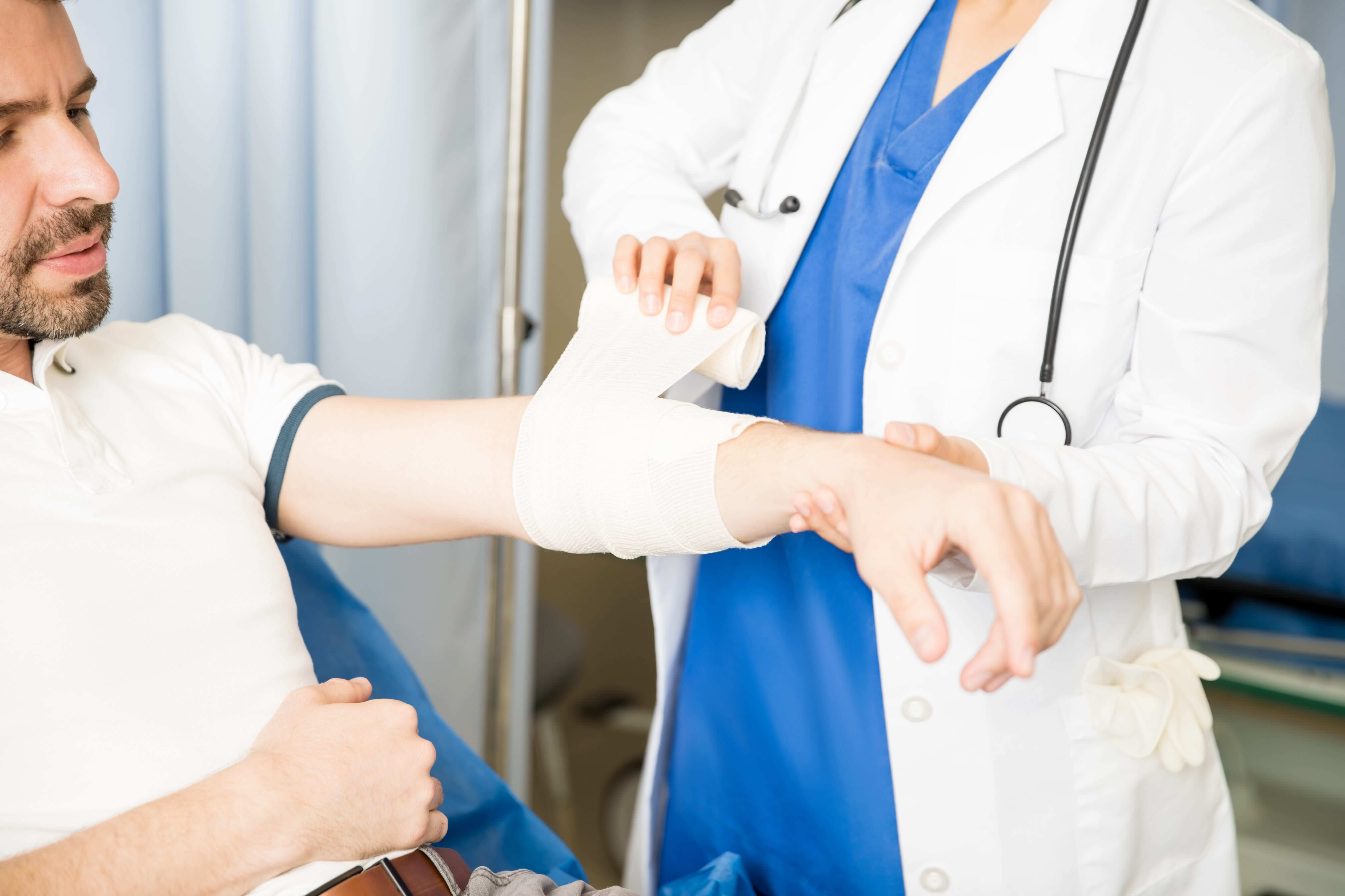 Doctor wrapping patient's arm worker's compensation, personal injury, and wrongful death legal services - Popowski & Shirley, P.A. - Columbia, SC